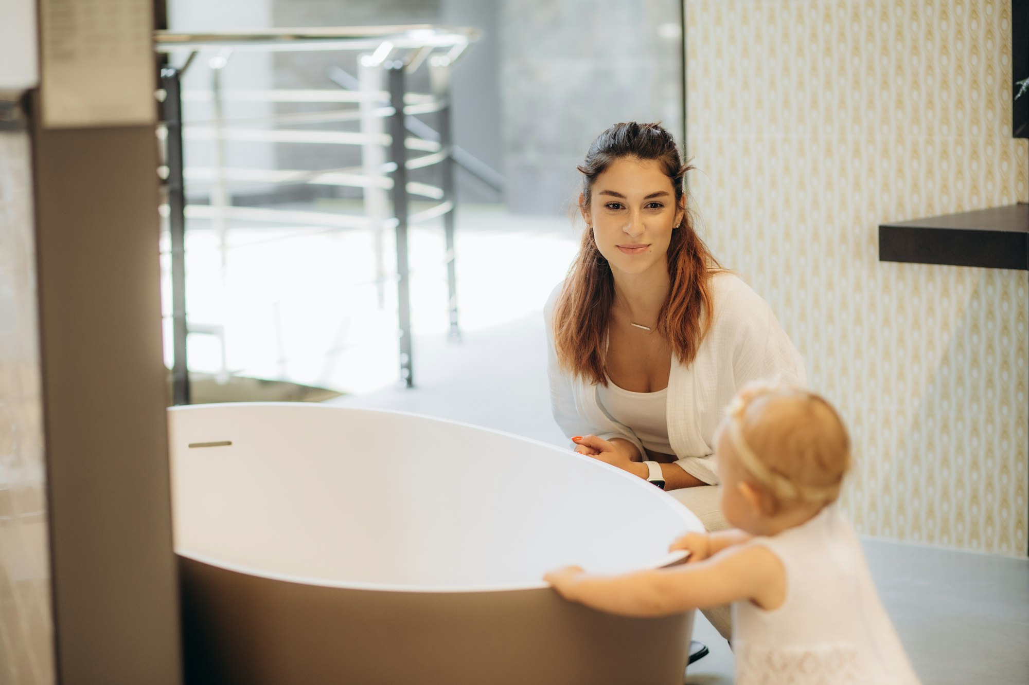 mother and child buy a bath in the bathroom