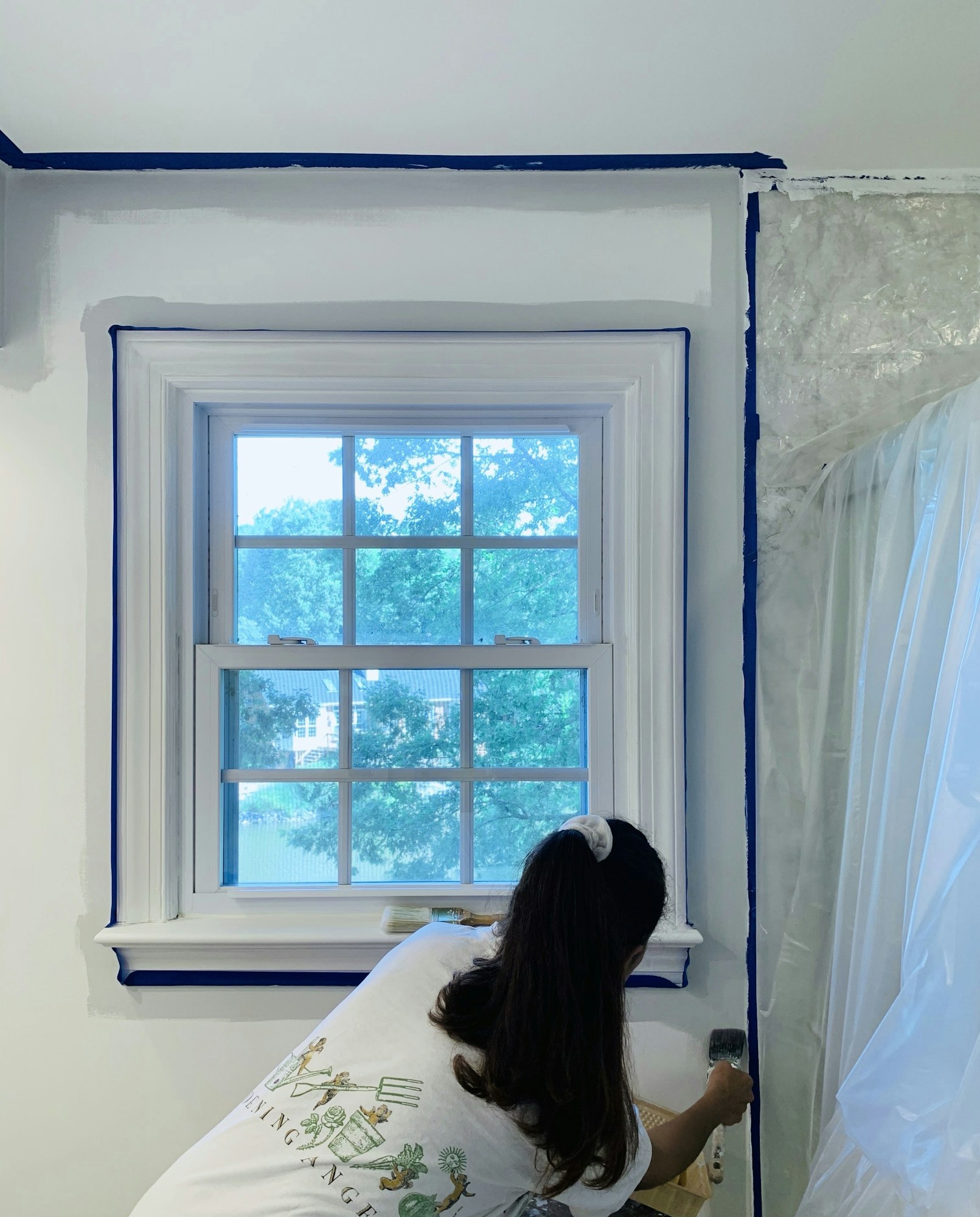 Woman enjoys a project painting home bathroom after shower imprisonment renovations.